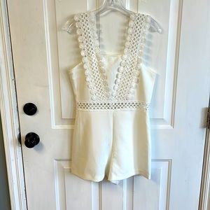 White, womens Medium romper from the boutique “Vestique”.
